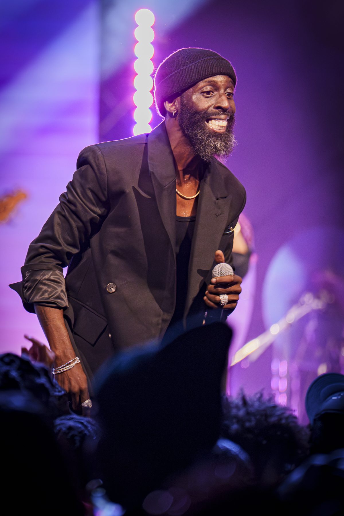 Performer on stage in purple light