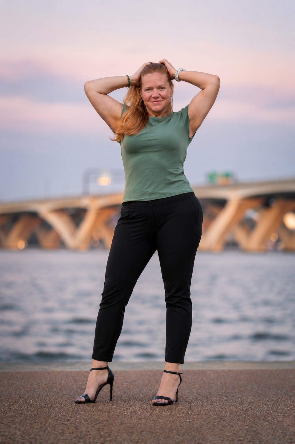 Outdoor portrait of a woman at the waterfront at dusk