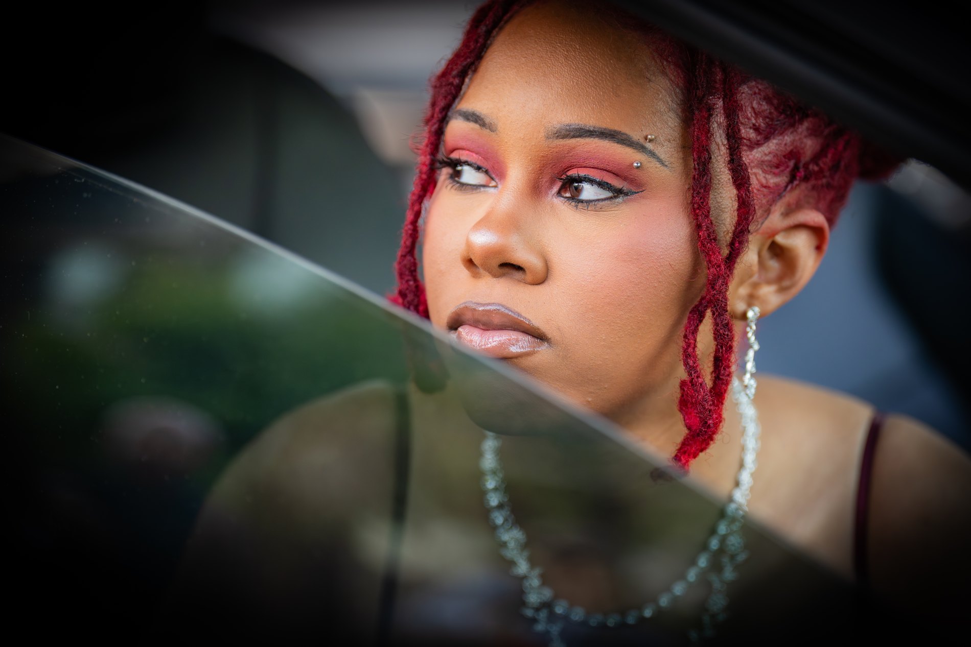 Portrait reflected through a car window